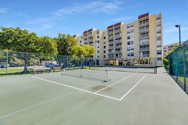 a view of a tennis ground with a large windows