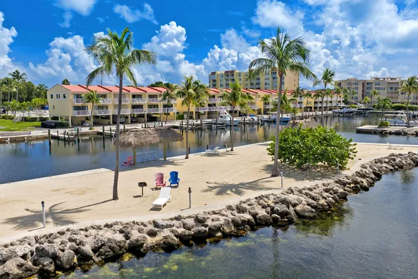a backyard of a house with barbeque oven table and chairs