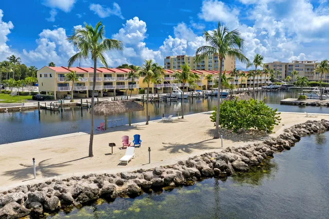 a backyard of a house with barbeque oven table and chairs