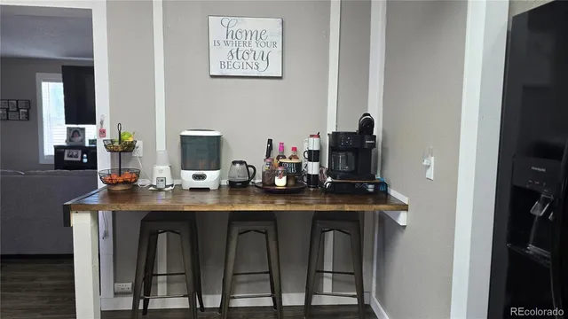 a dining table with chairs and wooden floor