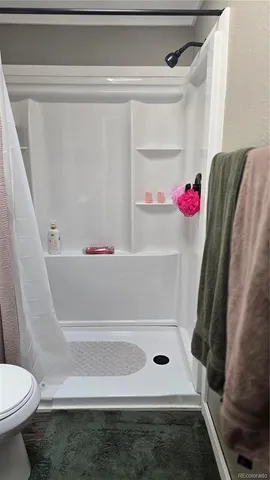 a bathroom with a bathtub and toilet