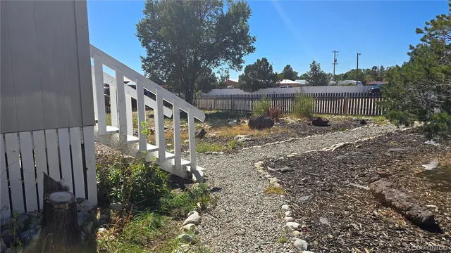 a view of a house with a yard and a pond
