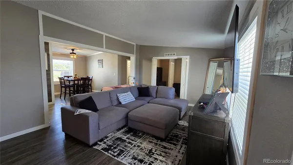 a living room with furniture and a mirror