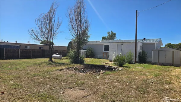 a backyard of a house with a table and chairs