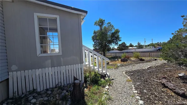 a balcony with wooden fence and trees