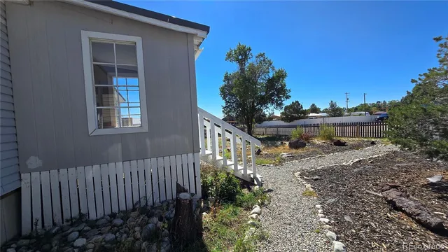 a balcony with wooden fence and trees