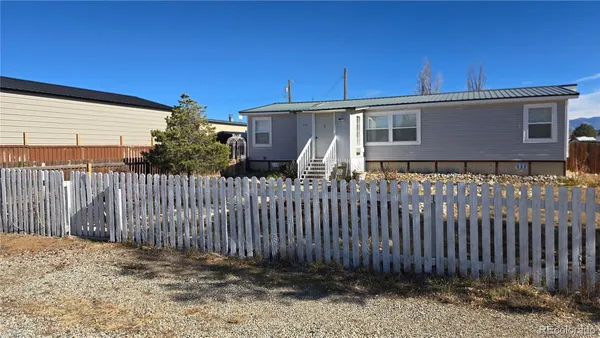 a front view of a house with wooden fence