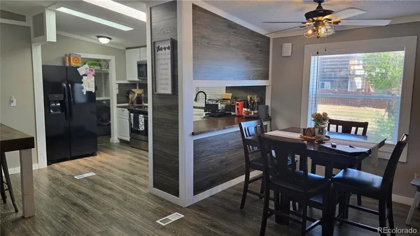 a view of a dining room with furniture window and wooden floor