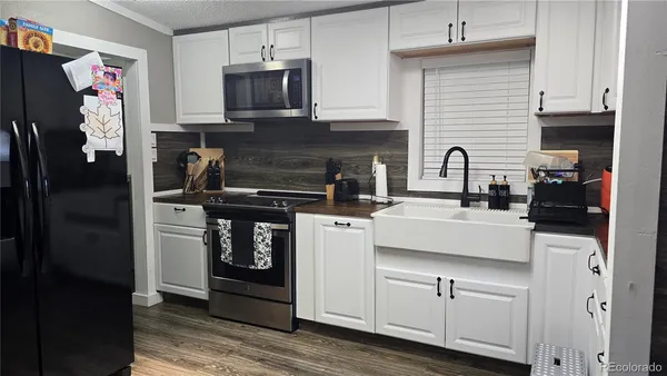 a kitchen with stainless steel appliances granite countertop a refrigerator and a stove top oven