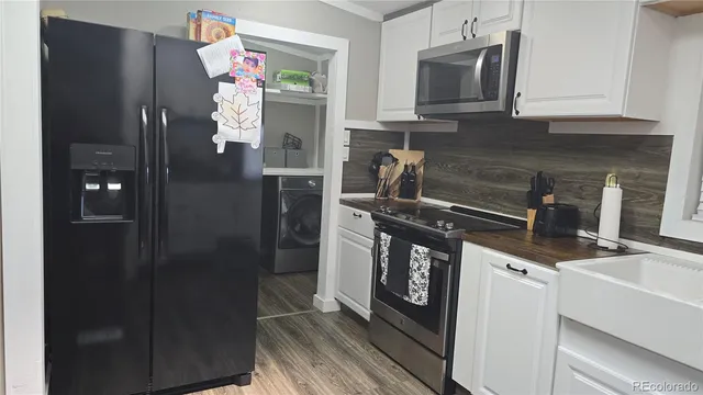 a kitchen with stainless steel appliances granite countertop a refrigerator and a stove top oven