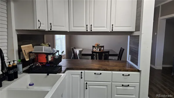 a kitchen with stainless steel appliances granite countertop a sink dishwasher and cabinets with wooden floor
