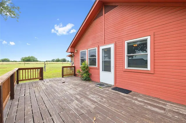 a view of a house with a patio and wooden floor