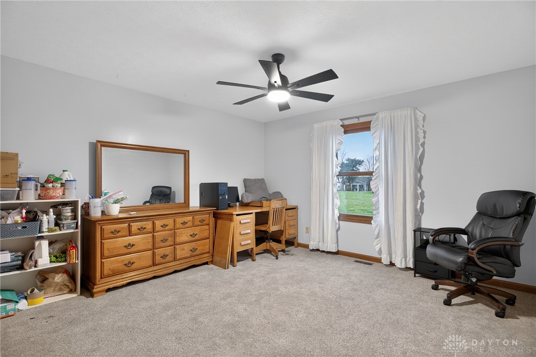5264 Frazier-Guy Road Sidney, OH 45365 - Photo 27 of 51 This spacious bedroom offers ample natural light and plush carpeting, creating a comfortable living space.