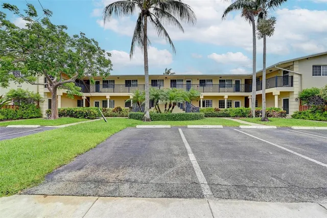 a front view of multiple houses with yard