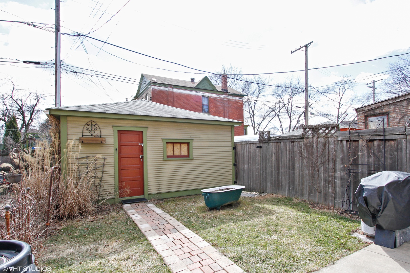 525 East 112th Street Chicago, IL 60628 - Photo 20 of 21 a view of a house with a small yard and wooden fence