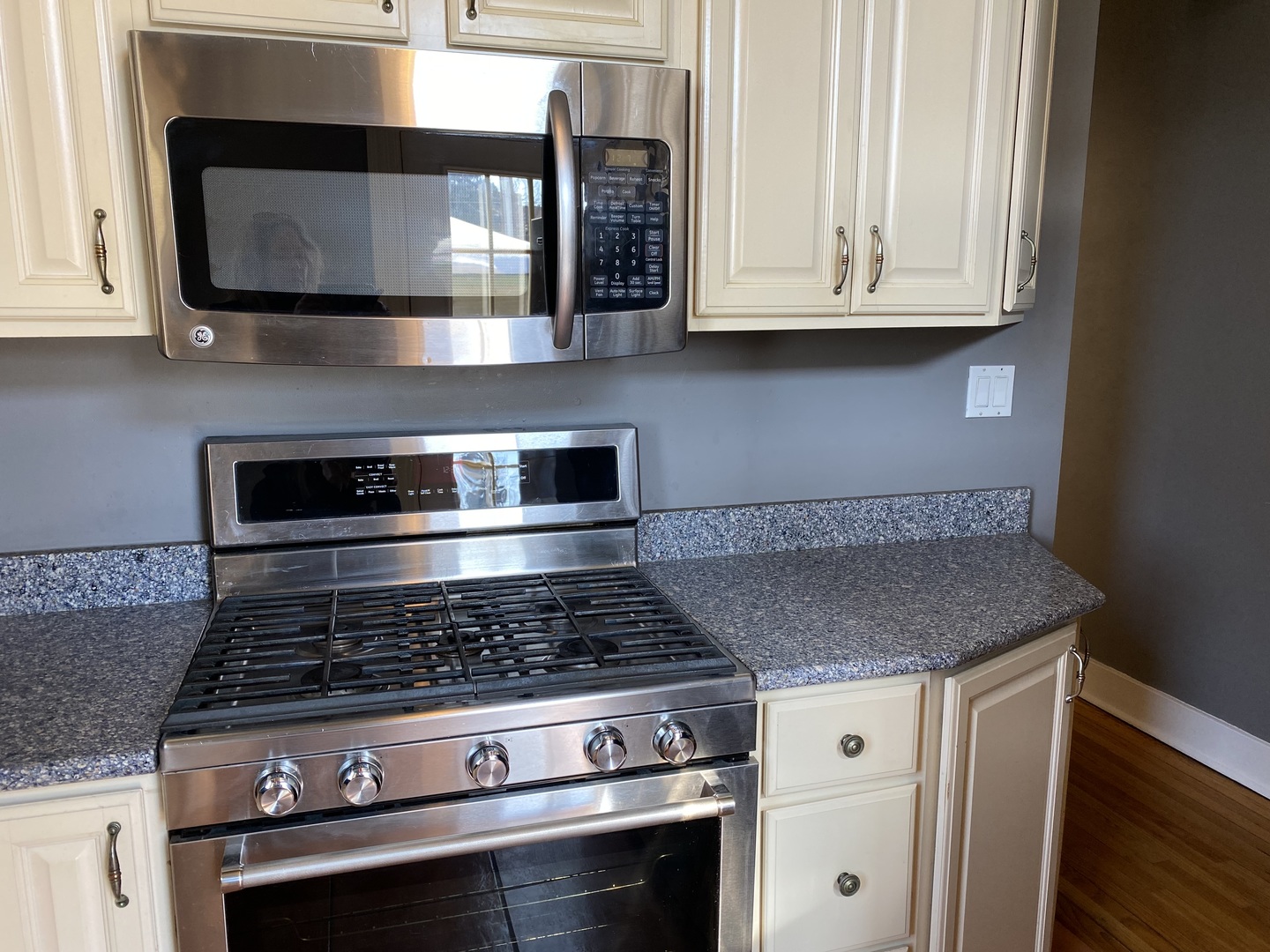 525 East 112th Street Chicago, IL 60628 - Photo 6 of 21 a kitchen with granite countertop white cabinets and stainless steel appliances