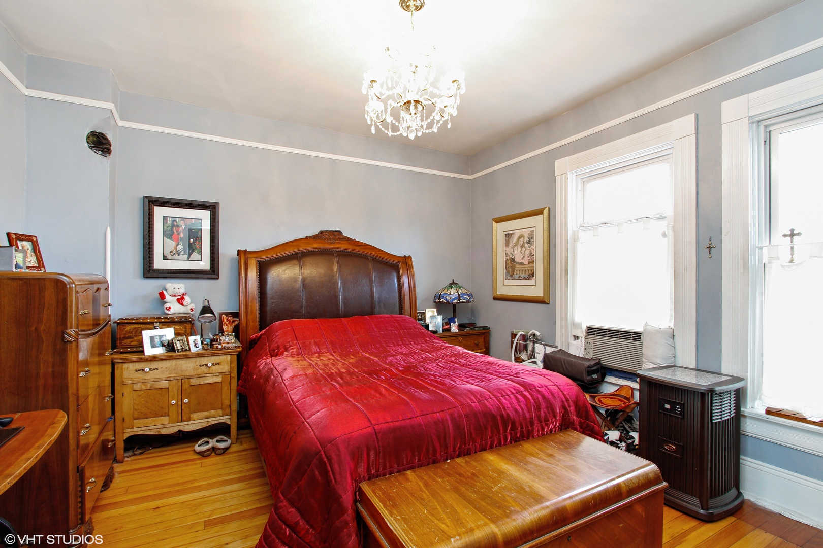 525 East 112th Street Chicago, IL 60628 - Photo 9 of 21 a bedroom with a bed and a chandelier