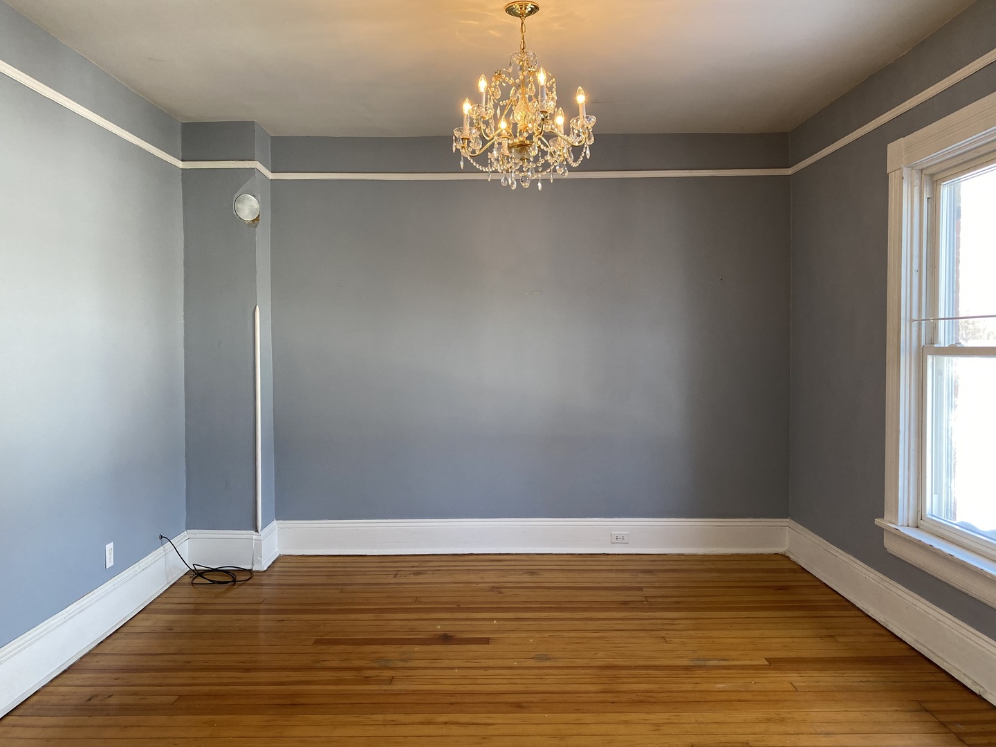 525 East 112th Street Chicago, IL 60628 - Photo 10 of 21 a view of a room with wooden floor and window