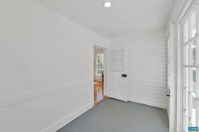 a bathroom with a granite countertop sink a mirror a bathtub and next to a window