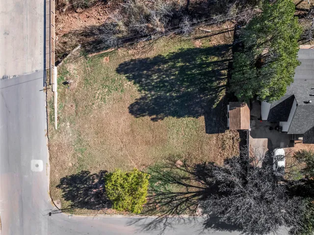 a picture of a yard with wooden fence