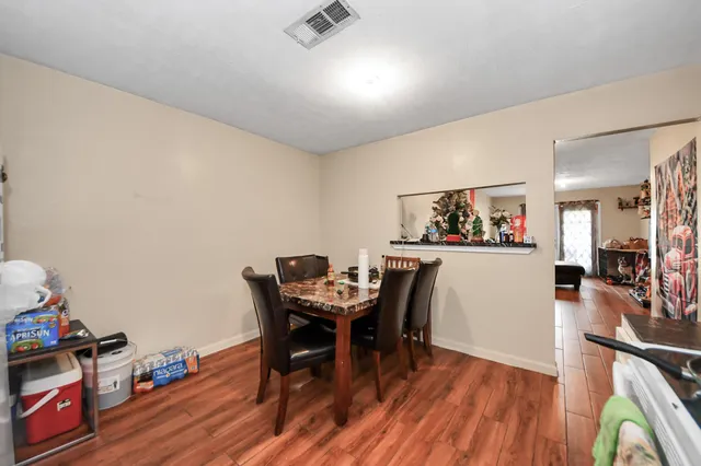 a view of a dining room with furniture and wooden floor