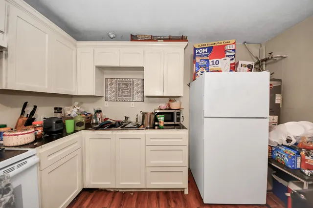 a white refrigerator freezer sitting inside of a kitchen