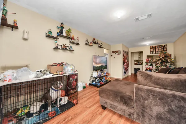 a living room with furniture and a wooden floor