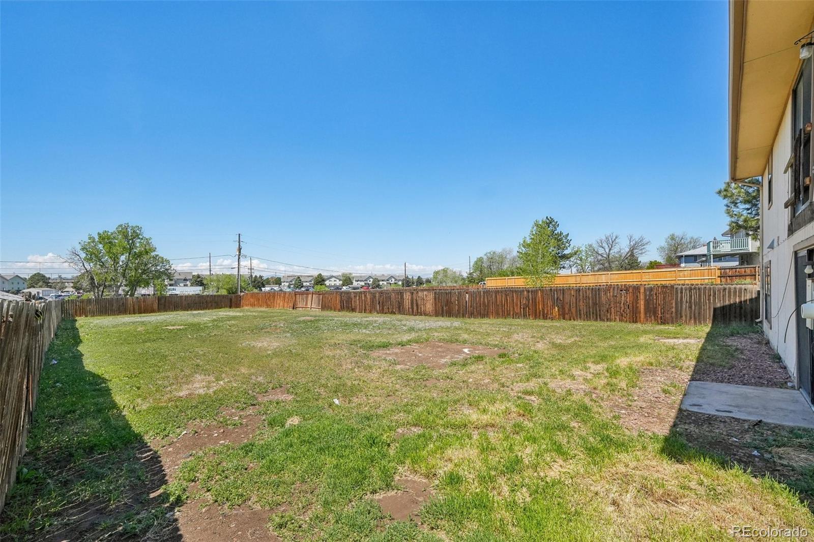 831 Sable Boulevard Aurora, CO 80011 - Photo 40 of 50 a view of a yard with a house