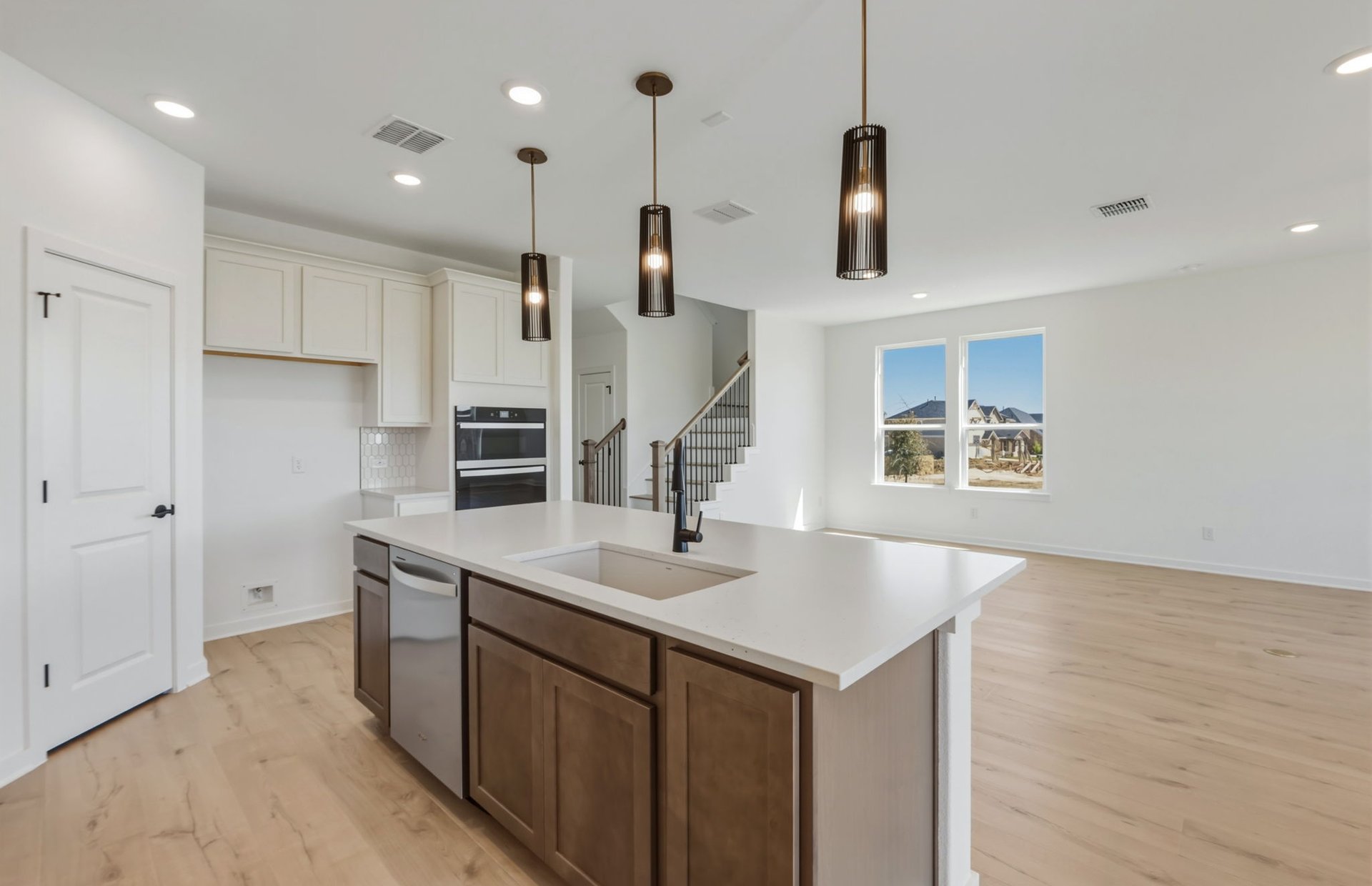 536 Rubber Tree Way Buda, TX 78610 - Photo 6 of 32 a kitchen with kitchen island a sink stainless steel appliances and cabinets