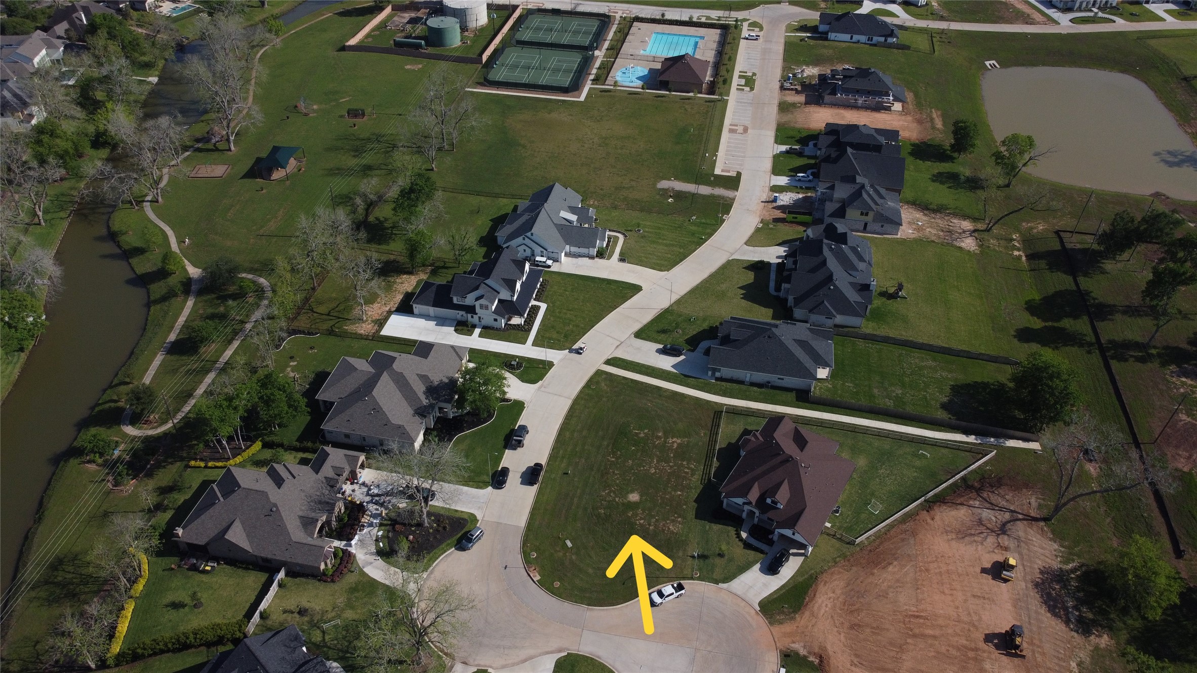 View of lot and Family Pool, Splash Pad, Tennis Courts and Park facilities right down the street