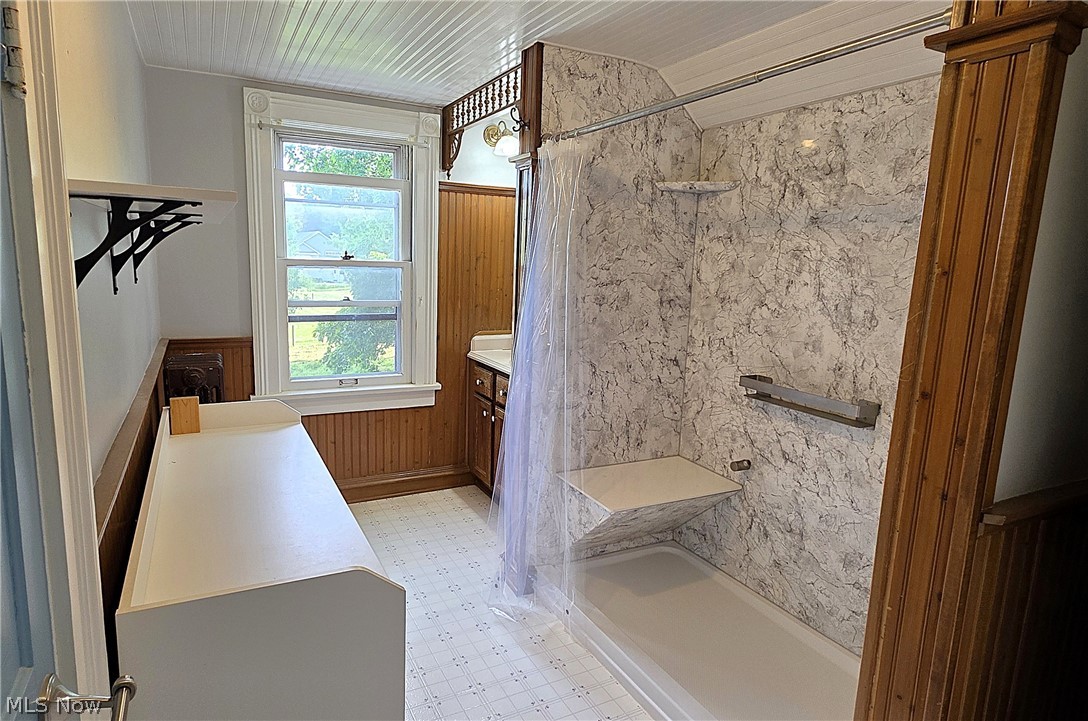 7414 Greenwich Road Seville, OH 44273 - Photo 28 of 50 Updated full bath featuring a newer large shower, vinyl flooring, and convenient storage closet.