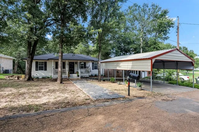 a view of a house with a backyard and chairs