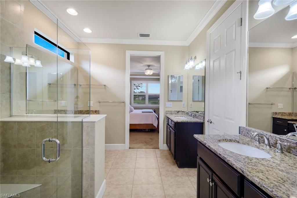 10820 Rutherford Road Fort Myers, FL 33913 - Photo 25 of 42 Dual vanity with granite countertops, tile flooring, glass-enclosed shower, transom window, and recessed lighting