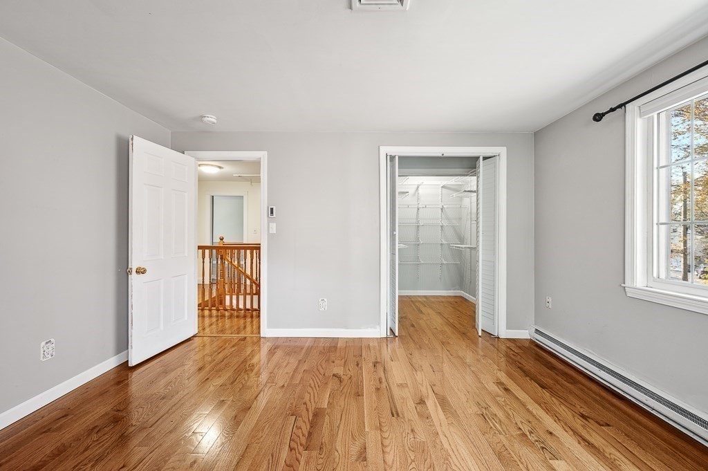 194 Paine Street Bellingham, MA 02019 - Photo 16 of 28 wooden floor in an empty room with a window