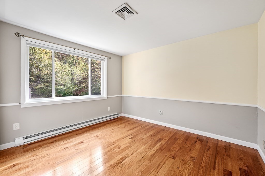 194 Paine Street Bellingham, MA 02019 - Photo 18 of 28 wooden floor in an empty room with a window