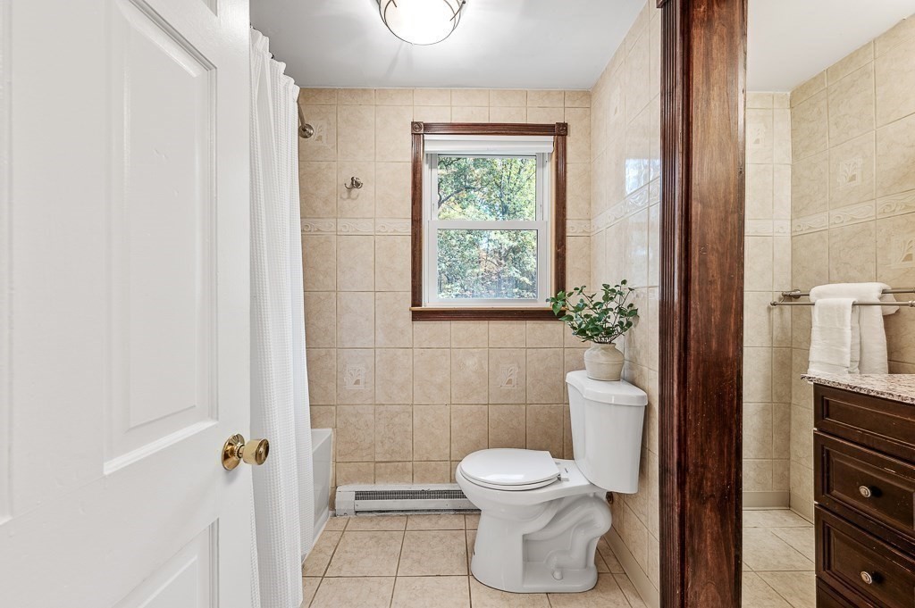 194 Paine Street Bellingham, MA 02019 - Photo 19 of 28 a bathroom with a toilet and a shower
