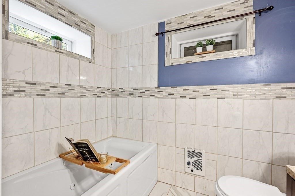 194 Paine Street Bellingham, MA 02019 - Photo 21 of 28 a bathroom with a toilet a sink and mirror