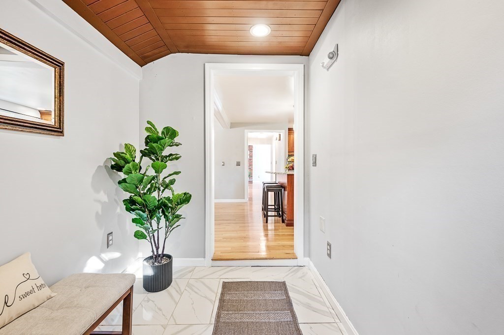 194 Paine Street Bellingham, MA 02019 - Photo 7 of 28 a room with potted plants and a wooden floor