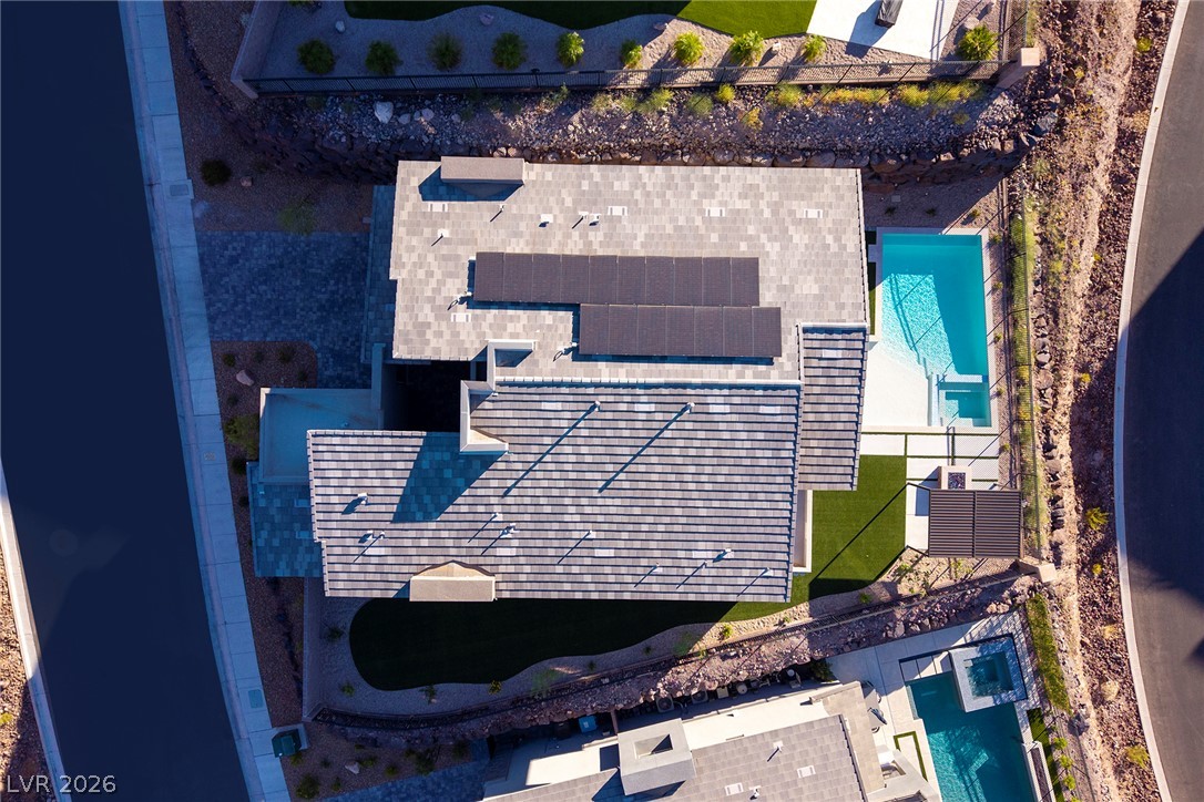 526 Riley Ridge Henderson, NV 89012 - Photo 10 of 10 An aerial perspective reveals a modern home with solar panels and a refreshing in-ground pool.