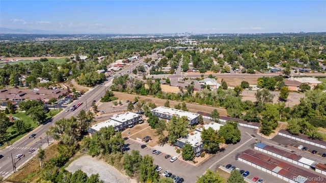 an aerial view of residential houses with outdoor space and trees