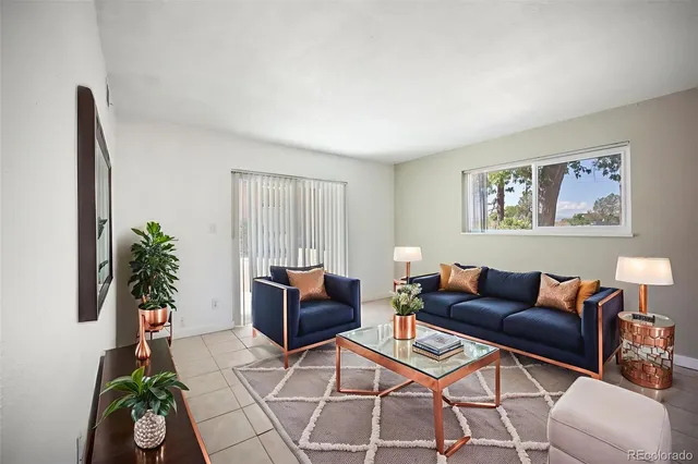 a living room with furniture and a potted plant