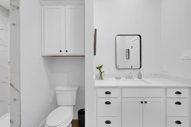 a spacious bathroom with double vanity sink a mirror and vanity