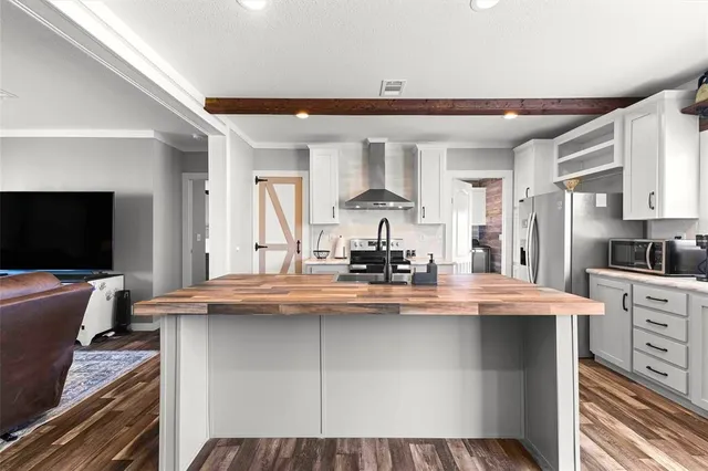a kitchen with kitchen island granite countertop a sink cabinets and stainless steel appliances