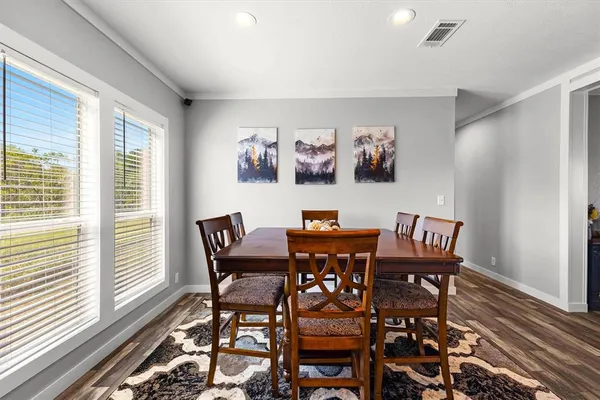 a view of a dining room with furniture window and wooden floor