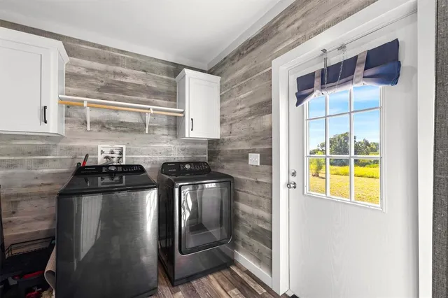 a kitchen with stainless steel appliances granite countertop a sink and a stove next to a window