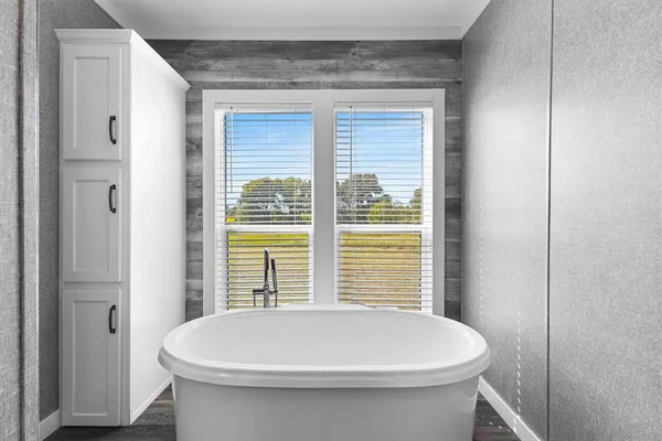 a bathroom with a white toilet and a window