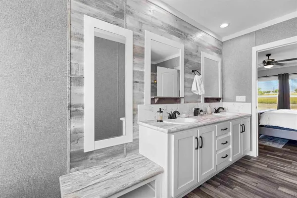 a spacious bathroom with a double vanity sink and a mirror