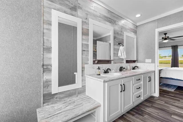 a spacious bathroom with a double vanity sink and a mirror