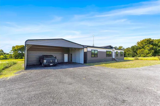 a view of a house with swimming pool and a yard