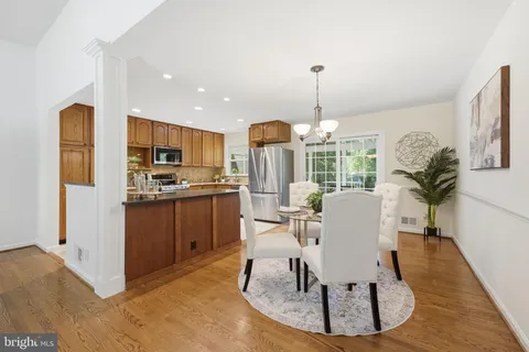a kitchen with kitchen island a refrigerator and a stove